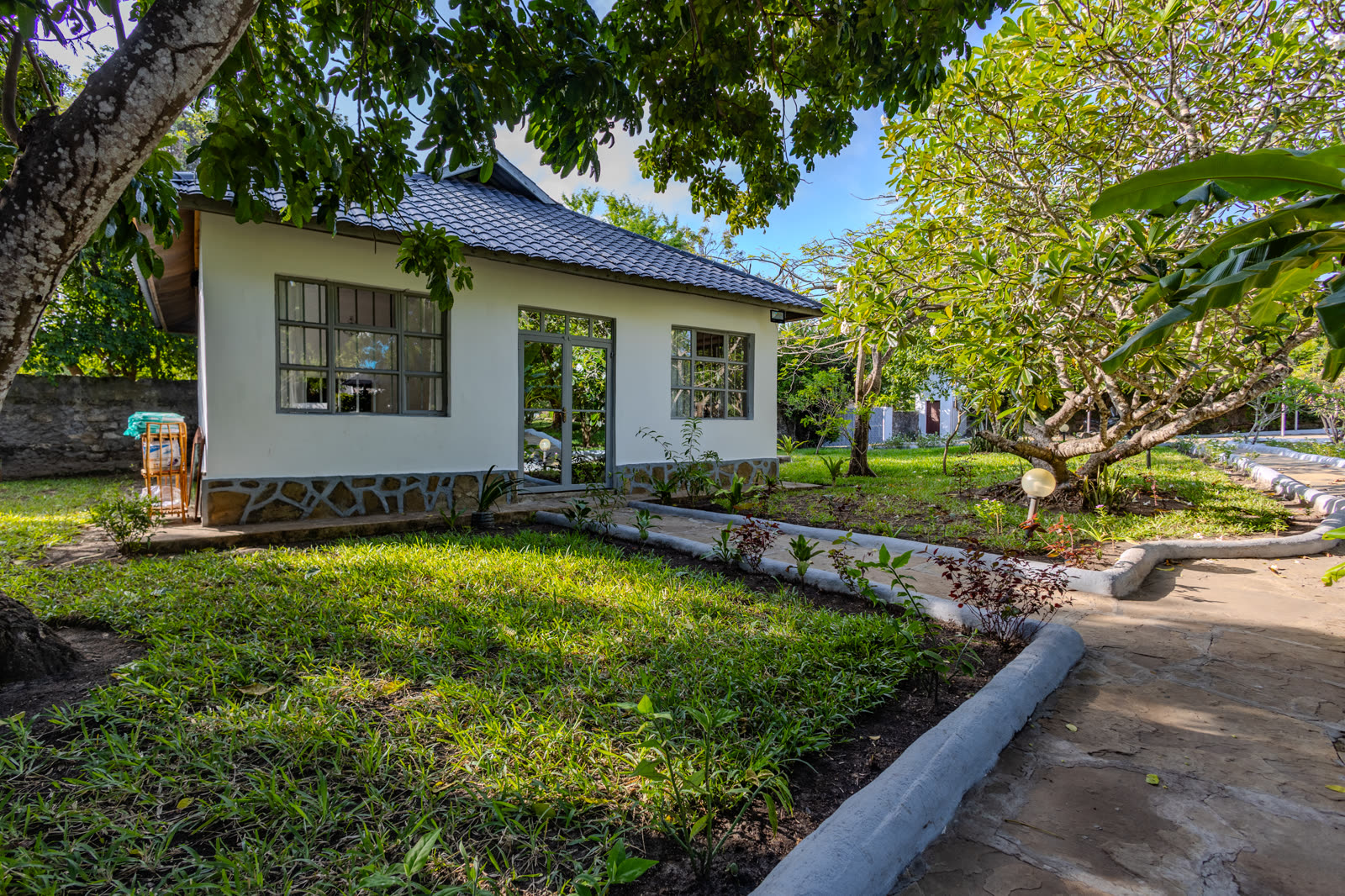 The two-bedroom villa at Auregi Kwitu set among garden trees