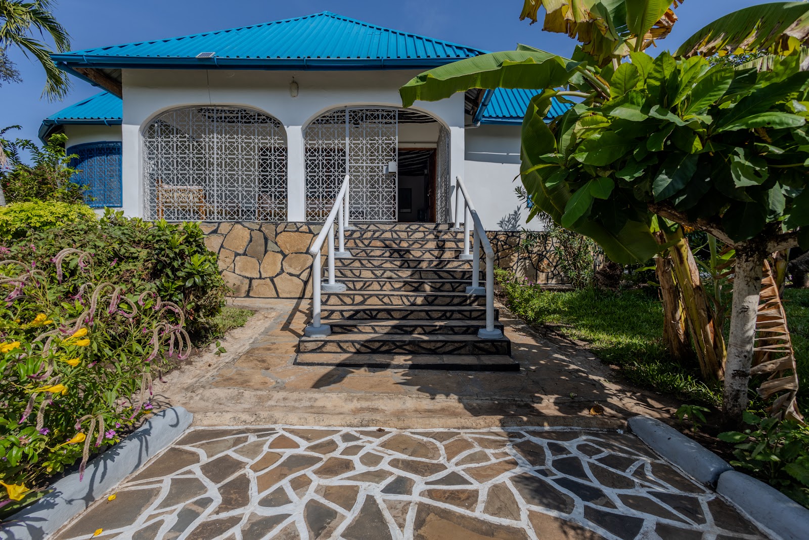 Stone steps rising through the Auregi Kwitu gardens