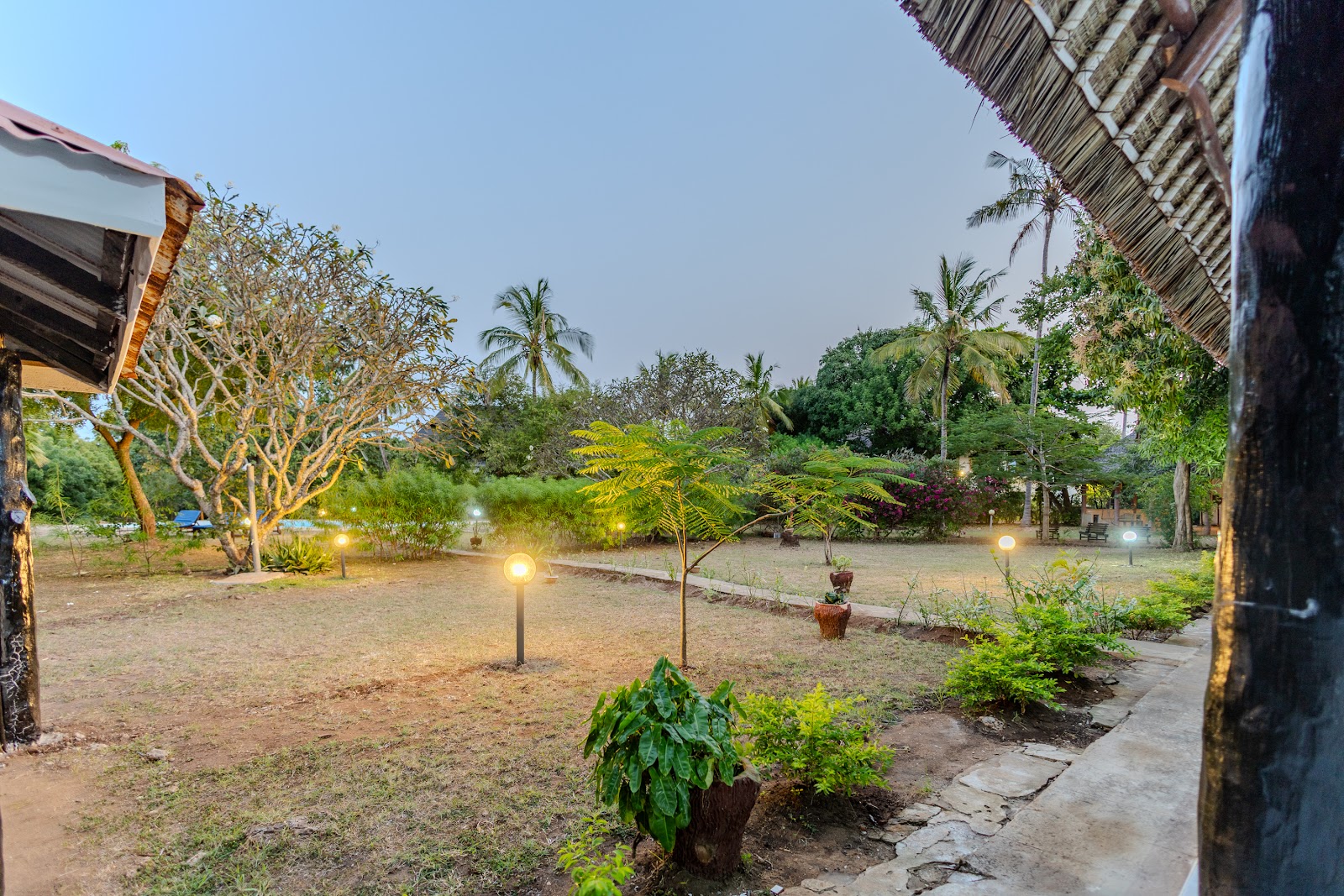Garden pathway lit at dusk at Auregi Kivulini