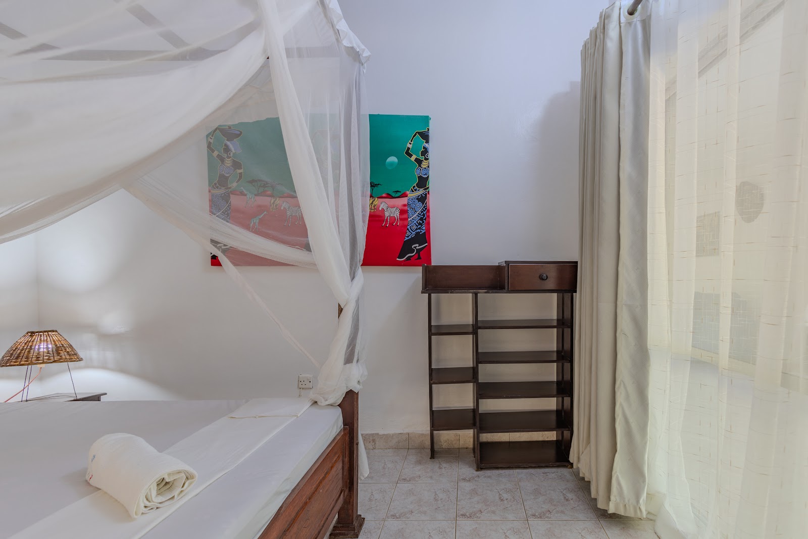 Four-poster bed draped with a mosquito net