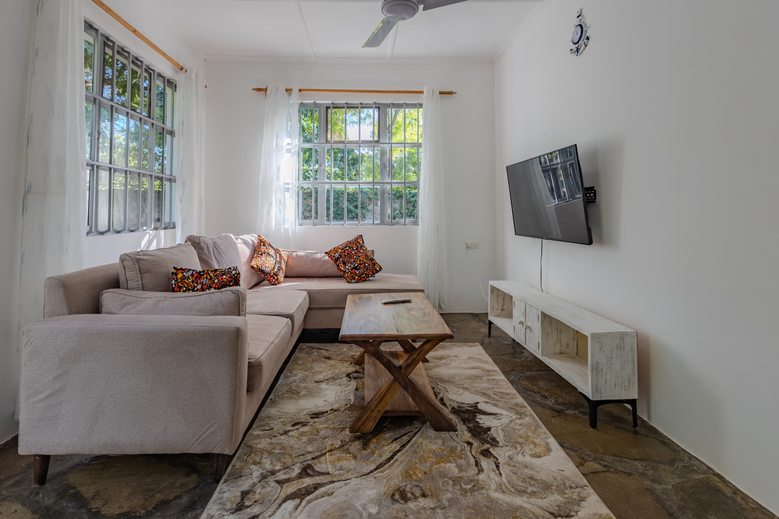 Living room with sofa and television in the two-bedroom villa