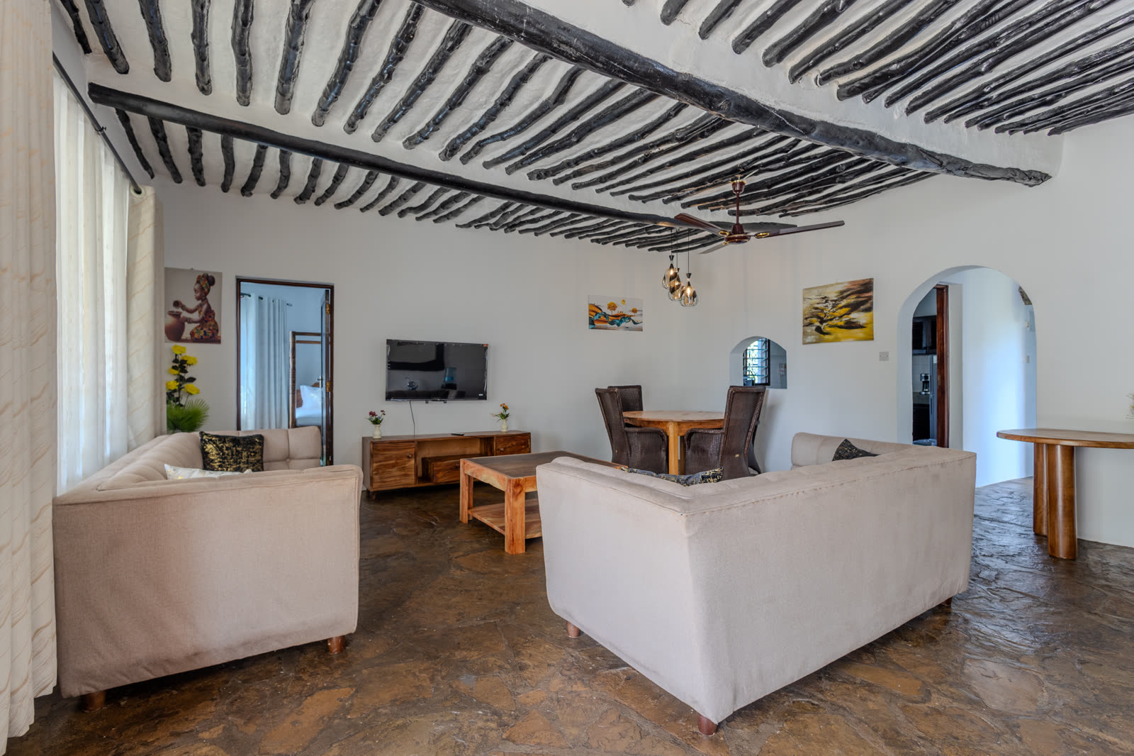 Living room with mangrove-pole ceiling in the three-bedroom villa
