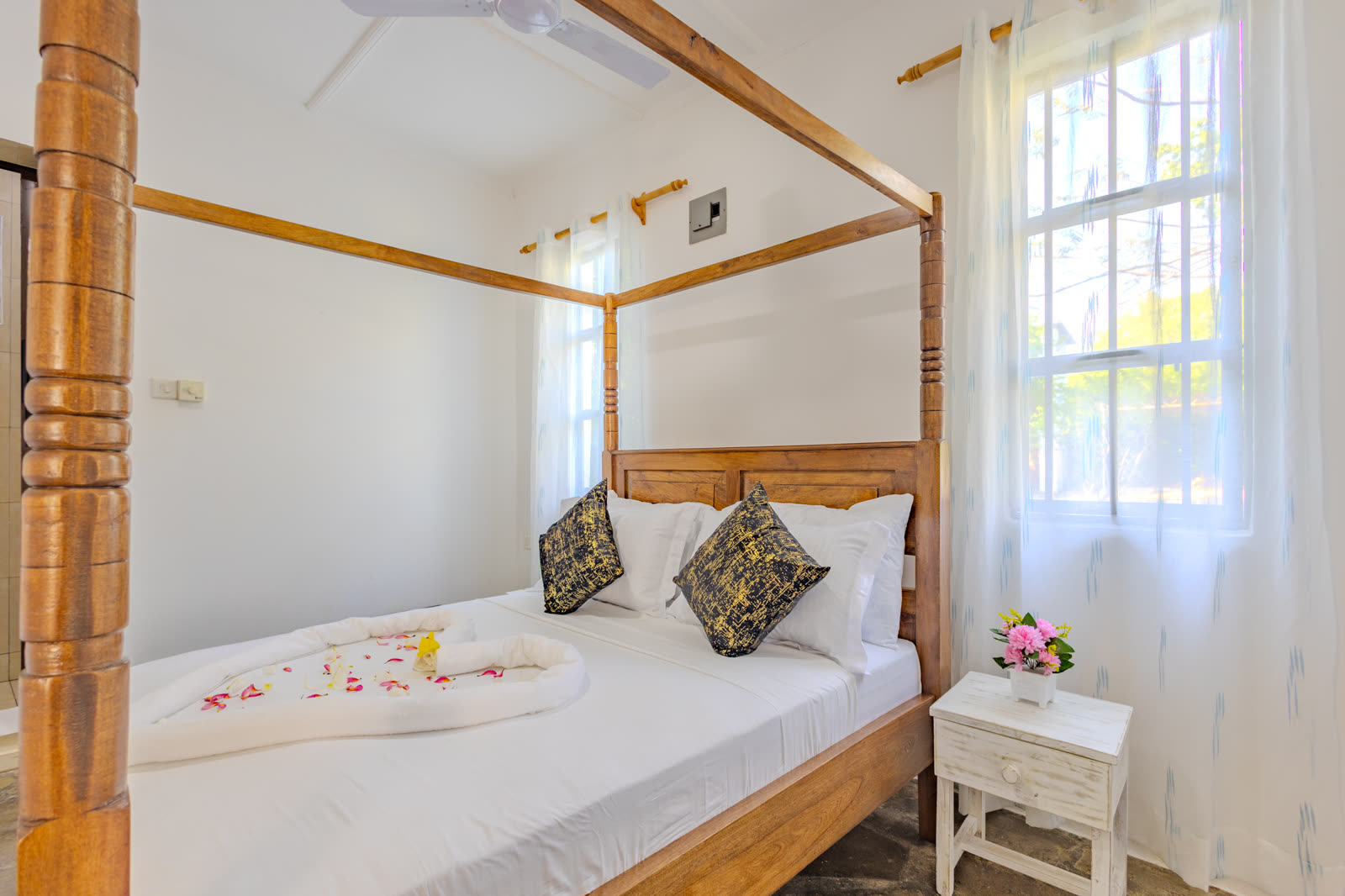 Second bedroom with four-poster bed in the two-bedroom villa