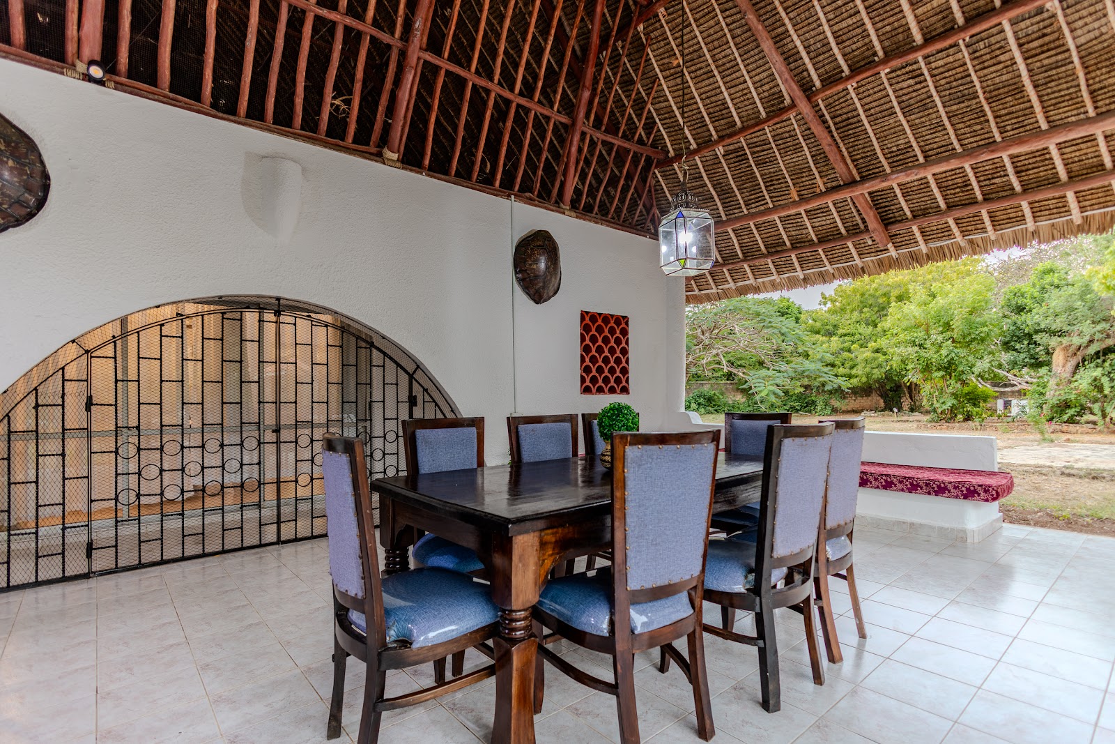 Long dining table under the makuti roof