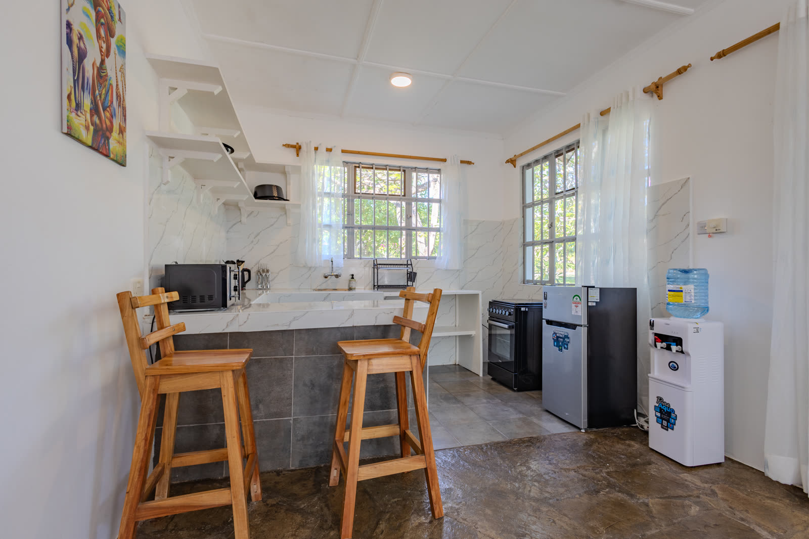 Marble-topped kitchen with breakfast stools in the two-bedroom villa